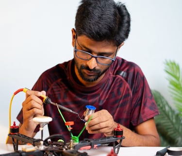 a man is sitting at a table with a small toy