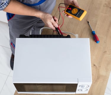 a man in a blue apron and a white shirt is holding a multimetered