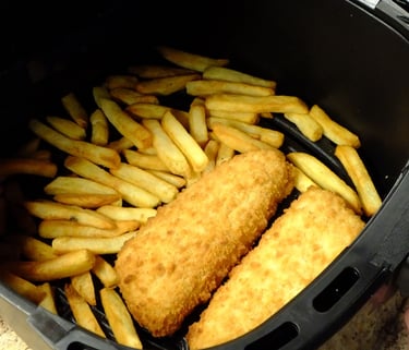 a person holding a fry fryer in a fryer