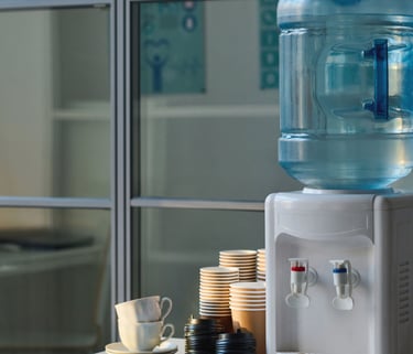 a water bottle with a water dispenser on top of a table