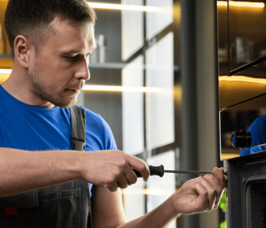 a man in a blue shirt is holding a knife and a knife in his hand