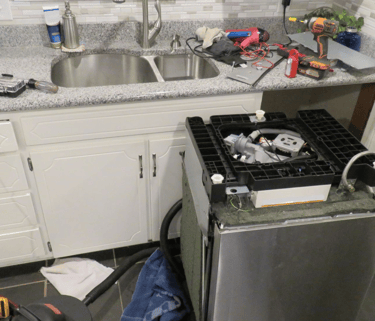 a kitchen with a stove top and a sink