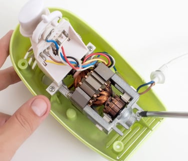 a person holding a small device with wires and wires