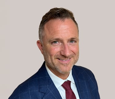 a man in a suit and tie smiling