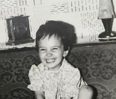 a toddler laughing towards the camera