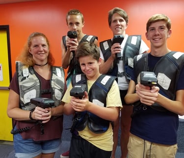 family posing for laser tag