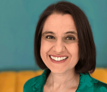 Dr Neha Dadheech, a GP exam prepartion coach smiling towards the camera.