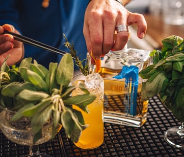 a man is preparing to make a tequila cocktail with a bottle of uno tequila añejo