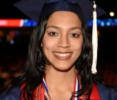 Headshot picture of Taylor guy in a graduation cap and gown.