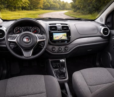 Interior do Fiat Palio com painel simples, volante Fiat, instrumentos analógicos e console central 