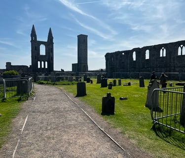a cemetery with a church ruins and a tower
