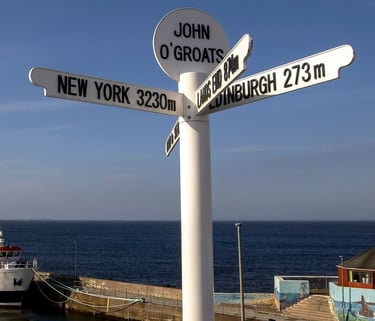 a sign post with a boat in the background