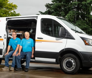 John and Dave sitting in their service truck