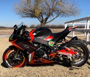 aprilia RSV4 motorcycle wrapped with fluorescent red. wrapped wheels. Italian colors with carbon
