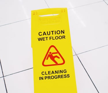tile and grout cleaning with yellow caution sign 