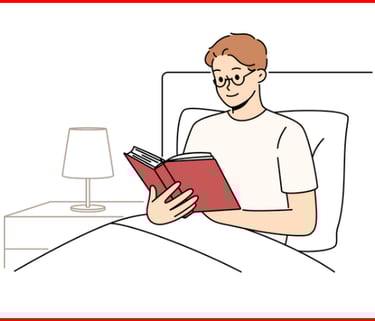 a man reading a book in bed with a lamp on the side