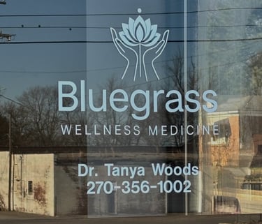 Glass entry door with Bluegrass Wellness Medicine, Dr. Tanya Woods, 270-356-1002 written 