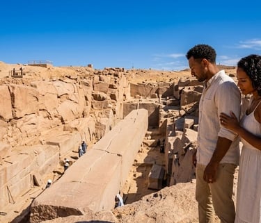 A couple overlooks the ancient Unfinished Obelisk in Aswan, Egypt, showcasing historic stone masonry.