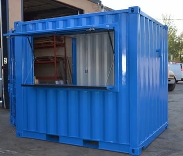 Blue modified shipping container kiosk with an open service window for a pop-up shop.