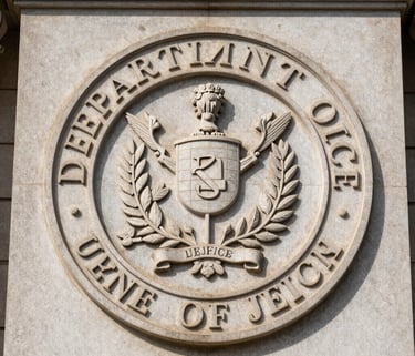 Detailed close-up of the official Department of Justice emblem carved into stone on a historic building facade, North American / US.