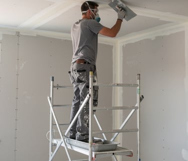 Professional Taper Jointer tool applying joint compound to drywall.