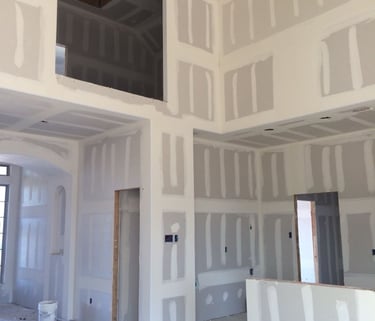 Taping jointer. Interior commercial construction work with metal ceiling structures and partitions.