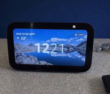 Smart display showing time, date, and weather on a countertop