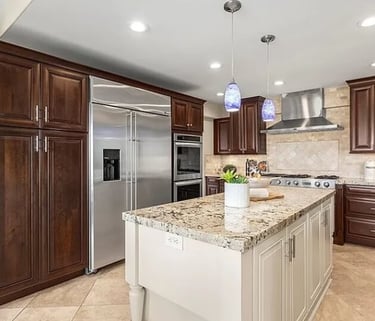 Kitchen remodel with wood cabinets, a center island, granite countertops, and appliances.