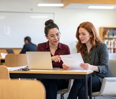 Illustration of two professionals reviewing course materials and evaluation documents.