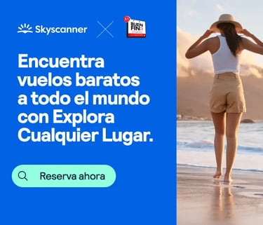 Skyscanner ad for cheap flights worldwide showing a woman walking on a beach at sunset.