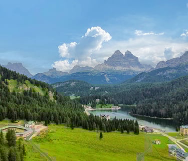a scenic view of a mountain range with a lake misurina and mountains in the background
