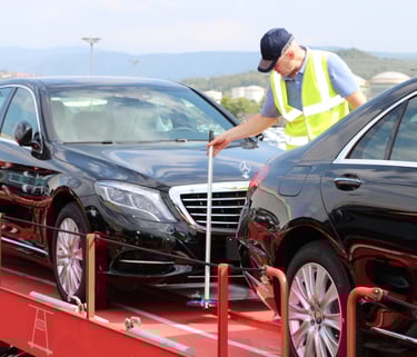 a man in a yellow vest is standing on a flatbed trailer