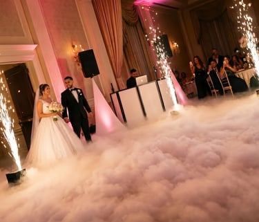 Bride and groom dancing on a cloud with indoor sparklers at a luxury wedding reception.