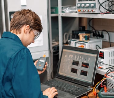 A man standing in front of a computer doing Sound Attenuation Field Testing