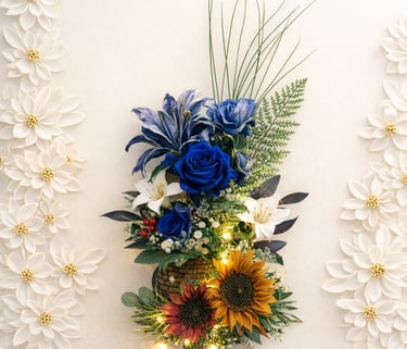 Elegant floral arrangement with blue roses, lilies, and sunflowers featuring warm LED fairy lights.