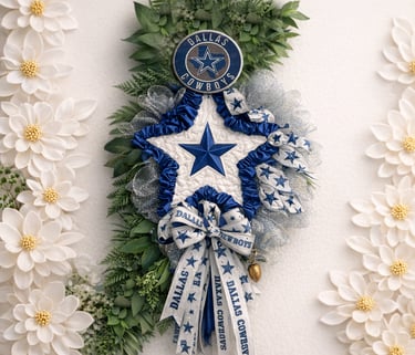 Decorative Dallas Cowboys wreath with blue star, team ribbons, and greenery against white flowers.