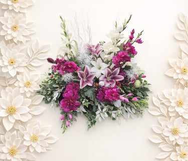 Elegant spray of pink lilies and purple flowers framed