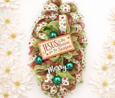 Religious Christmas door swag featuring red and green deco mesh, polka dot ribbons, and a Jesus is the Reason for the Season