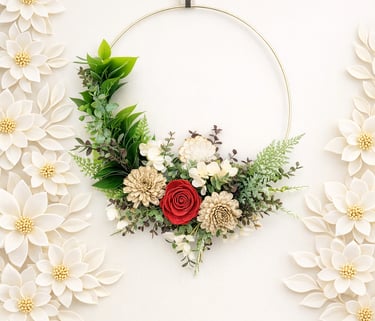Modern floral hoop wreath with a red rose and greenery on a white background with decorative paper flowers.