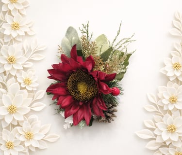 Red silk sunflower wrist corsage with winter greenery