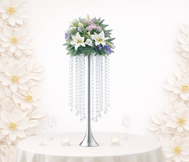 Elegant floral wedding centerpiece featuring white lilies and hanging crystals on a silver stand.