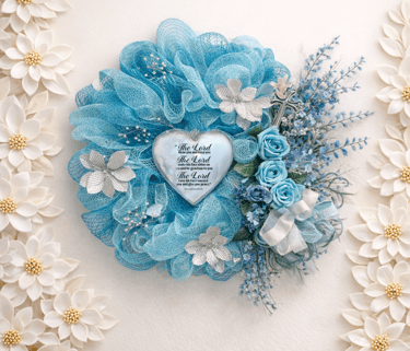 Blue mesh wreath with religious heart plaque, silver flowers, and a cross for home decor.