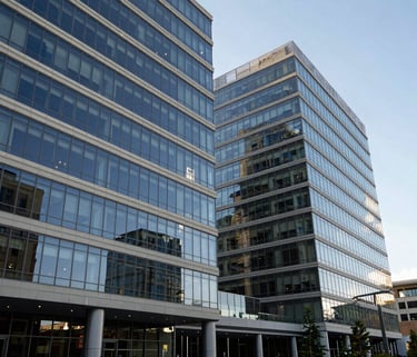 A wide-angle landscape photograph of the modern, glass-facade headquarters of a global foundation in Seattle, North American / US, with off-white and professional dark blue reflections.