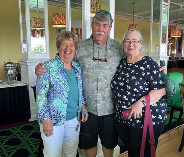 A picture of 2 women and a man in the middle.