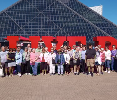A picture of people standing in front of the Cleveland Rock and Roll hall of fame.
