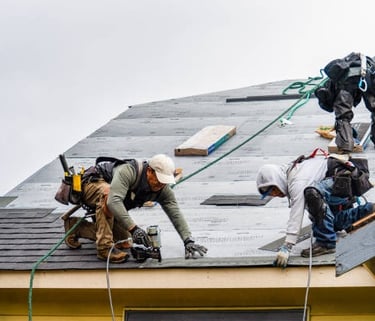 workers installing new roof tiles