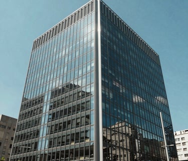 A wide photography shot of a modern glass-walled office building in a major South American city, reflecting a clear blue sky, symbolizing transparency and growth.