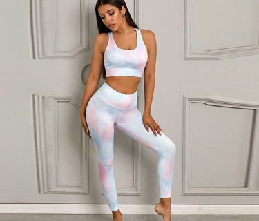 Woman wearing a pastel tie-dye yoga set with a sports bra and high-waisted leggings.