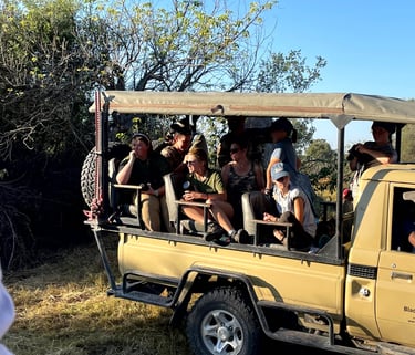 Students on a game viewer admiring wild animals