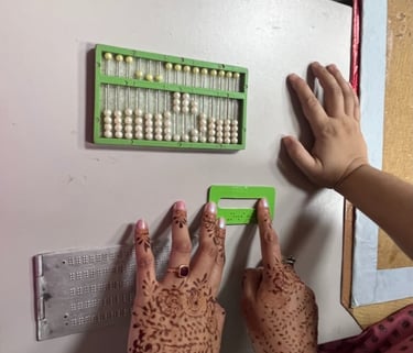 Image of two hands feelingtactile elements of study material for visually impaired